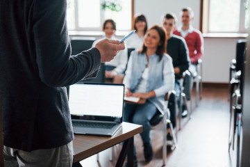 Everyone is smiling listens group people business conference modern classroom daytime